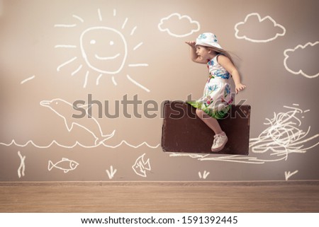 Happy kid playing with toy s boat indoors. Travel and adventure concept Kid having fun at home
