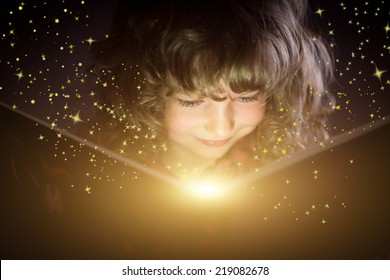 Happy kid reading magic book