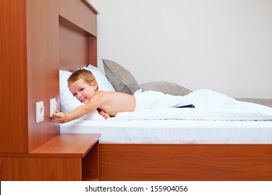 Happy Kid Ready To Sleep In Bedroom, Turning Off The Light