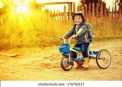 Happy kid riding a bike outdoors.