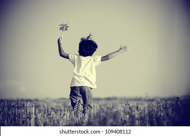 Happy Kid Running On Beautiful Field