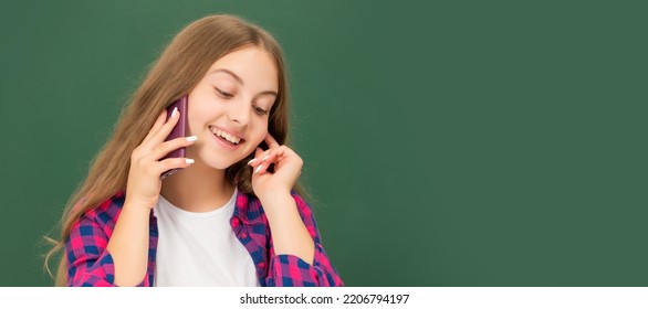 Happy Kid Speaking On Smartphone In Classroom At Blackboard, Copy Space, Conversation. Horizontal Isolated Poster Of School Girl Student. Banner Header Portrait Of Schoolgirl Copy Space.