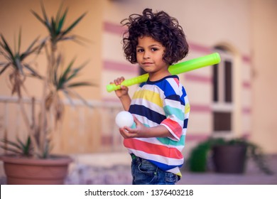 Happy Kid With Toy Baseball Equipment Outdoor. Children And Entertainment Concept