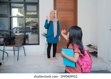 Happy Kid Wave Goodbye To Mother Before Going To School In The Morning