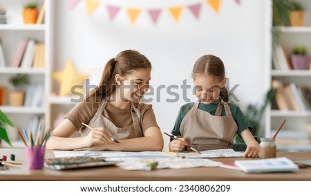 Happy kids at the art class. Children are painting together.