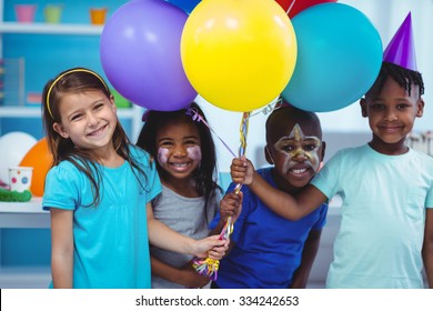 Happy kids with balloons at the birthday party