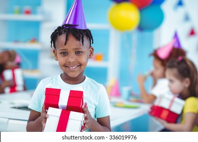 Happy Kids At A Birthday Party About To Open Presents