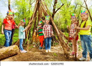 Happy Kids Building Wigwam In The Forest