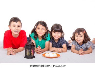 Happy Kids Celebrating Eid El Fitr - Muslim Children With Lantern And Ready To Eat Kahk ( Cookies) In The Feast