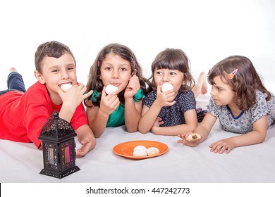 Happy Kids Celebrating Eid El Fitr - Muslim Children Eating Kahk - Kaak ( Cookies ) In The Feast

