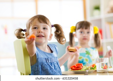 Happy Kids Eating Healthy Food In Kindergarten Or At Home