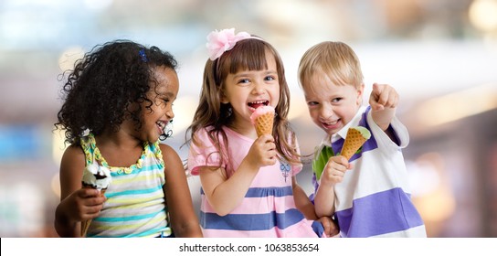 Happy Kids Eating Ice Cream At A Party In Cafe