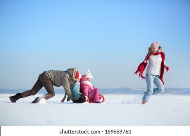 Happy Kids Enjoying Riding On Sledge