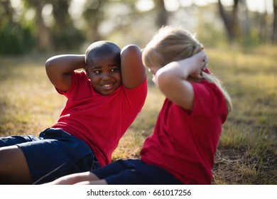 Happy Kids Exercising During Obstacle Course In Boot Camp