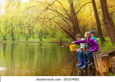 Happy Kids Fishing Together Near Beautiful Pond