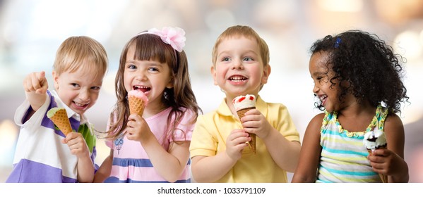 Happy Kids Group Eating Ice Cream At A Party In Cafe