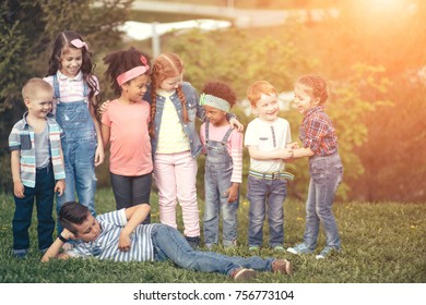 Happy Kids Group Have Fun In Nature Outdoors Park. The Concept Of Childhood, Friendship, Intercultural Communication.