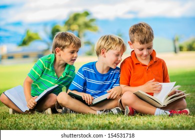 Happy Kids, Group Of Young Boys Reading Books Outside Together After School