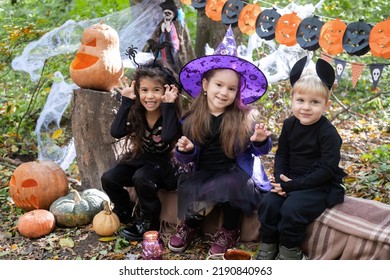 happy kids in halloween costumes having fun in halloween decorations outdoor - Powered by Shutterstock