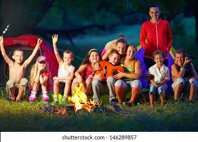 Happy Kids Having Fun Around Camp Fire