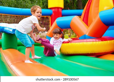 happy kids having fun on inflatable attraction playground - Shutterstock ID 289100567