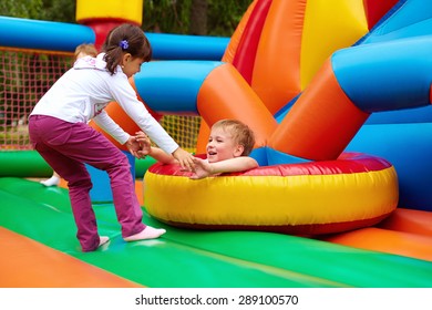 happy kids having fun on inflatable attraction playground - Shutterstock ID 289100570