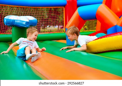 happy kids having fun on inflatable attraction playground - Shutterstock ID 292566827