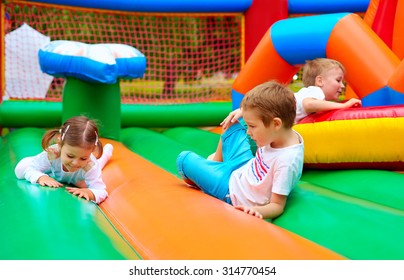 happy kids having fun on inflatable attraction playground - Shutterstock ID 314770454