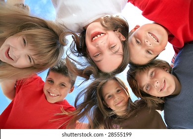 Happy Kids Huddling And Looking Down At The Viewer