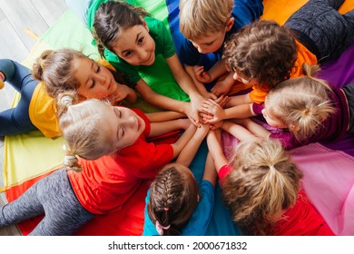 Happy kids laying on a floor in circle - Powered by Shutterstock