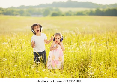 Happy kids listen music on nature