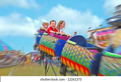 Happy Kids On Rollercoaster At Amusement Park