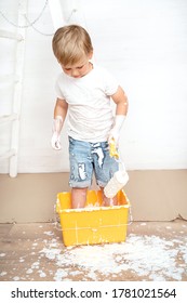 Happy Kids Painting Wall. Home Improvement And Renovation. Child Applying White Paint On Walls In Bedroom. Family Moving Into New House.