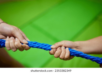 Happy kids with parents playing active games in summer park, tugging war - Powered by Shutterstock