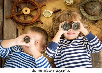 Happy Kids Playing With Nautical Things. Children Having Fun At Home. Travel And Adventure Concept. Unusual High Angle View Portrait