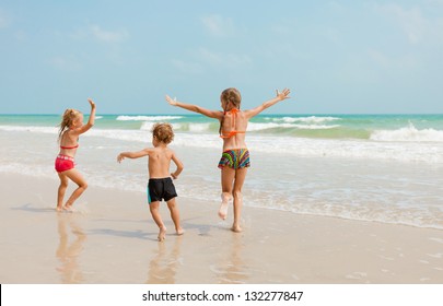 Happy Kids Playing On Beach