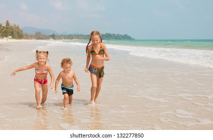 Happy Kids Playing On Beach