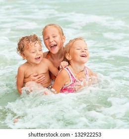 Happy Kids Playing On Beach