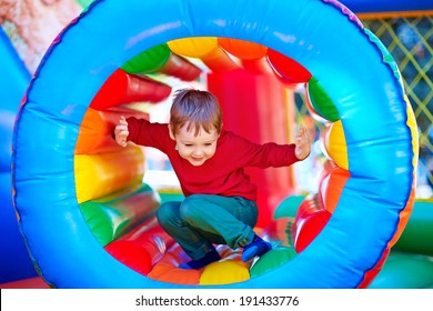 Happy Kids Playing On Inflatable Attraction Playground