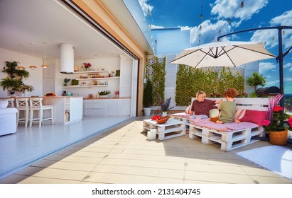 happy kids playing on rooftop patio with open space kitchen and sliding doors - Shutterstock ID 2131404745