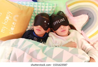 Happy Kids In Pyjamas Lying In The Bed With Sleeping Masks And The Writing  