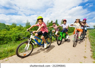 Happy Kids Riding Bikes Like In Race Together