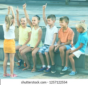 Happy Kids In School Age Playing Charades Outdoors