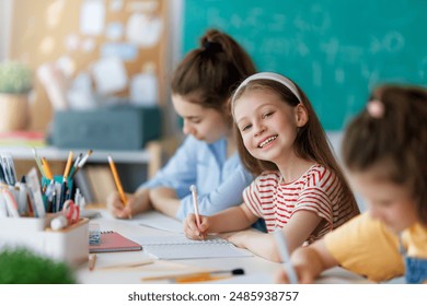 Happy kids at school. Children are learning in the class. - Powered by Shutterstock