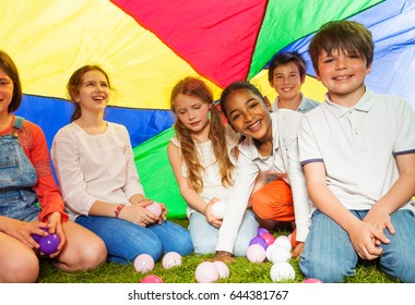 Happy Kids Sitting Under Canopy Made Of Parachute