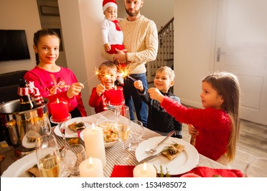 Happy kids with sparklers in hands at Christmas party at home. - Shutterstock ID 1534985072