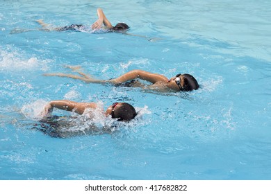 Happy Kids Swim Competition In Swimming Pool, Healthy Boy Water Sport Front Crawl Race In Summer