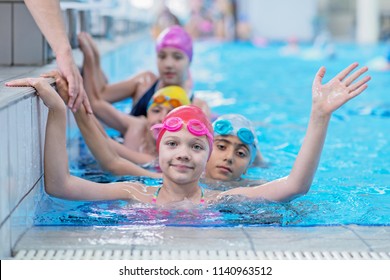 happy kids at the swimming pool. young and successful swimmers pose. - Shutterstock ID 1140963512