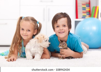 Happy Kids With Their Pets - A Dog And A Kitten, Laying On The Floor