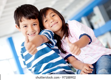 Happy kids with thumbs up and smiling